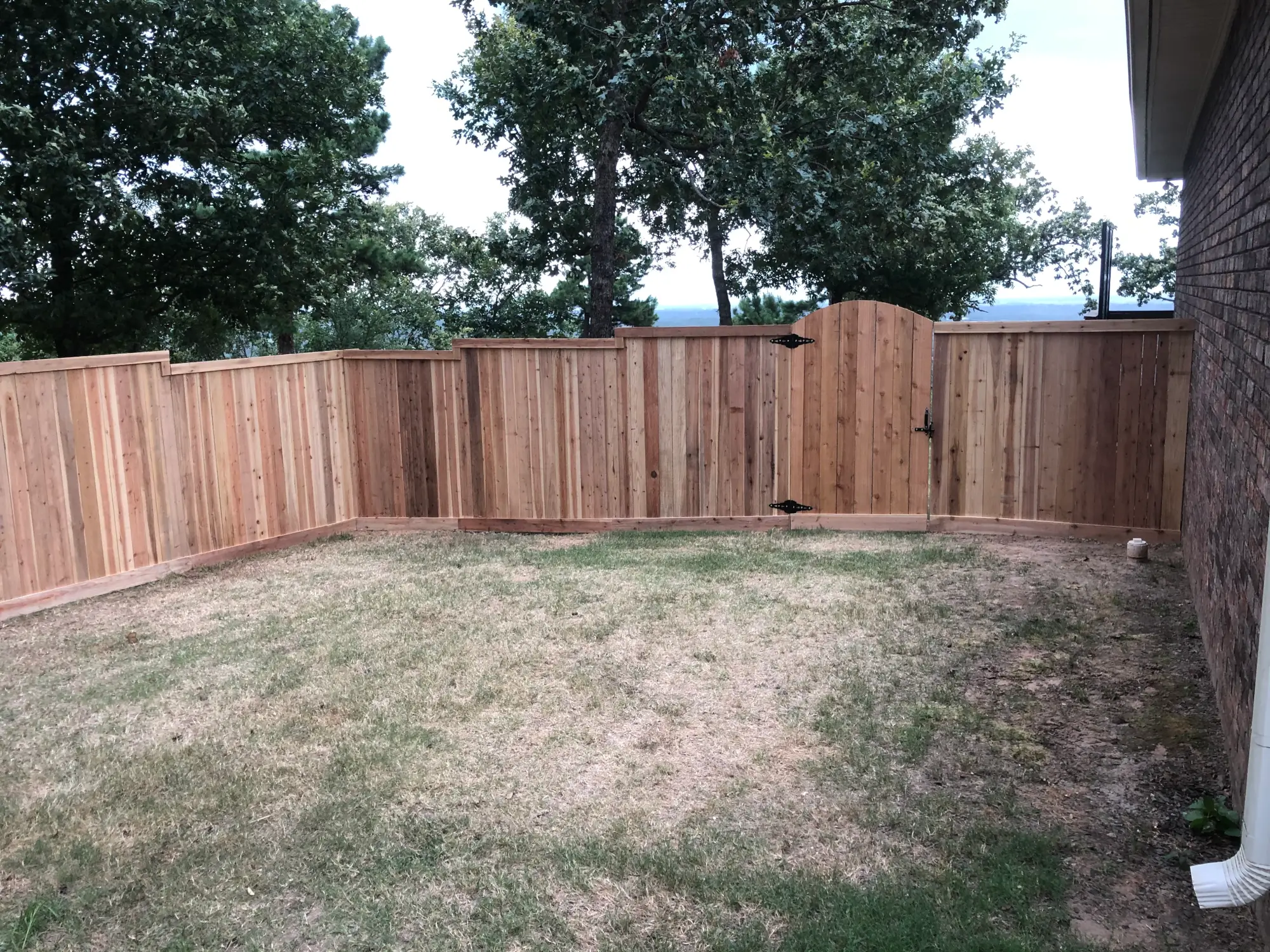 Residential wooden fence with arched gate
