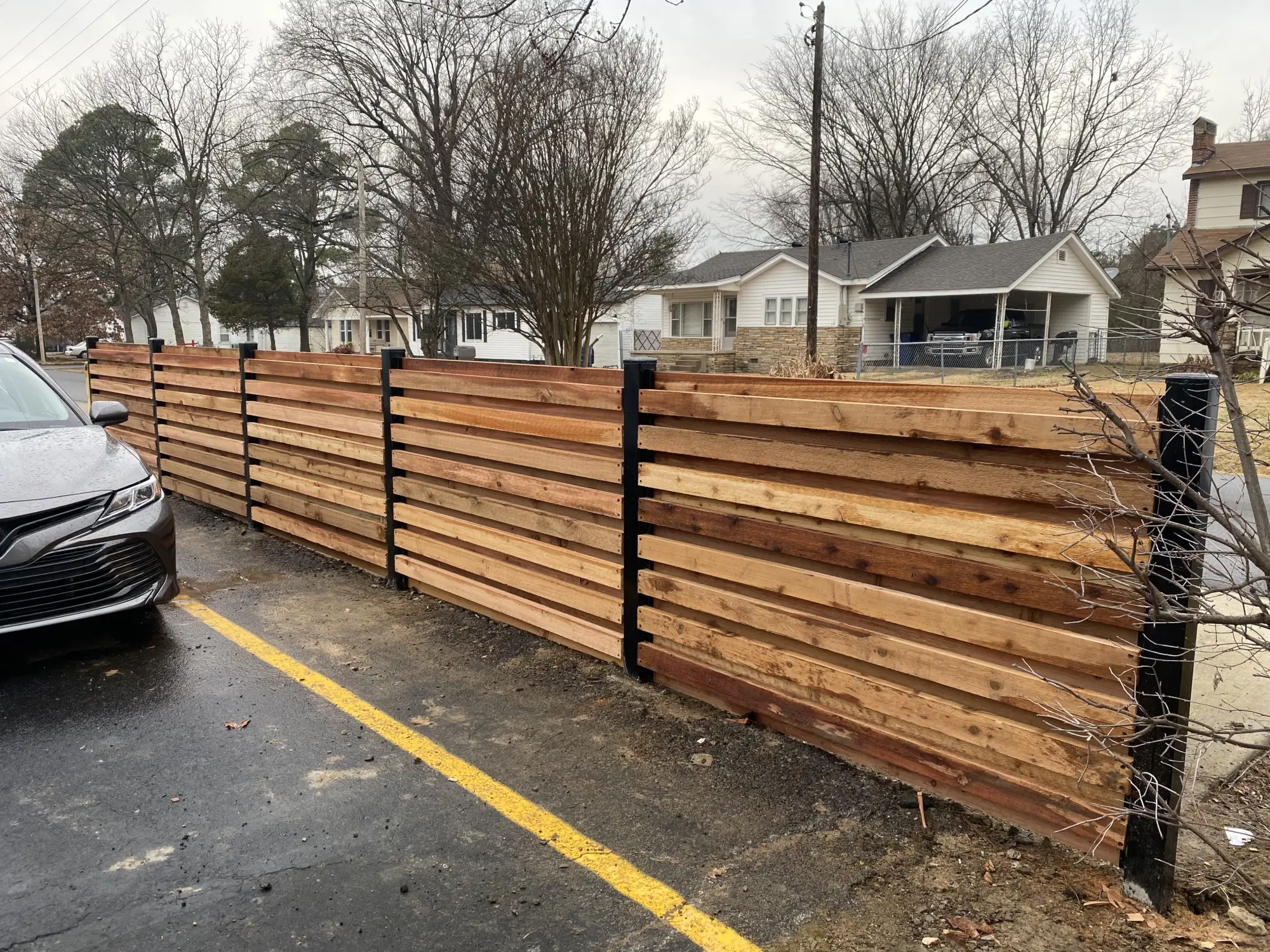 Wooden fence with black posts